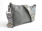 Rear view of the Starburn crossbody bag in pale grey leather and woven adjustable strap and silver hardware