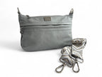 Light gray genuine leather crossbody bag with a detachable strap on a white background