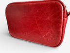 Back view of the Tiny Harriet bag, highlighting the texture of the red leather, the embossed Lilly & Jude logo and the small heart shaped motif stitched into the panel