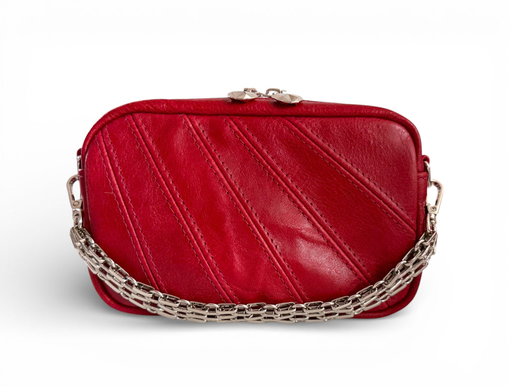 Mini panelled camera style bag, made using red, genuine leather, styled with a silver wristlet chain, which is available as an optional extra.