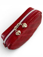 Red leather clutch with silver zipper and geometric shaped zipper pull / decorative elements on a white background
