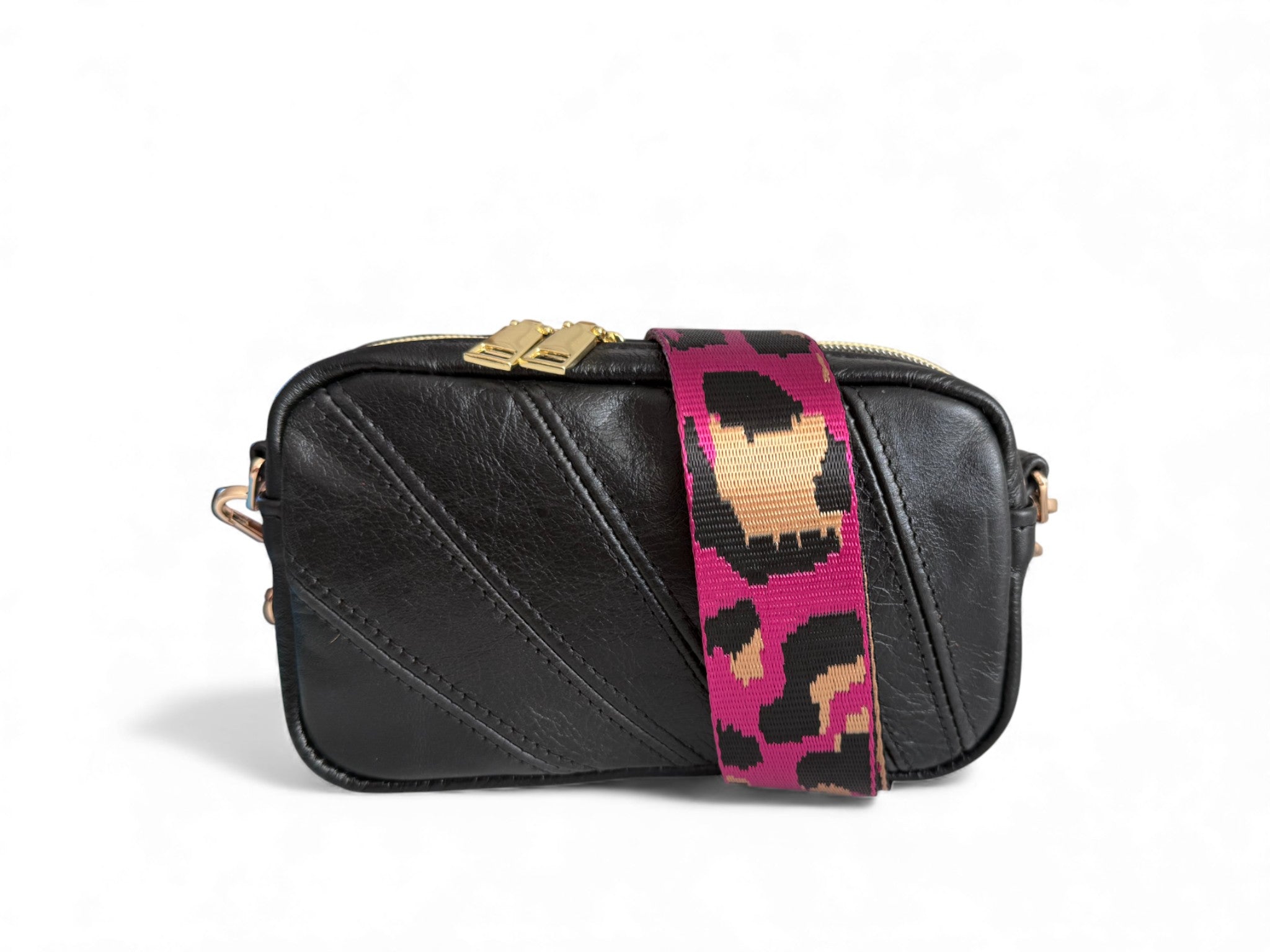 Small, black leather camera style bag with a colorful strap on a white background