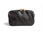 Black leather panelled crossbody handbag with gold zip on a white background