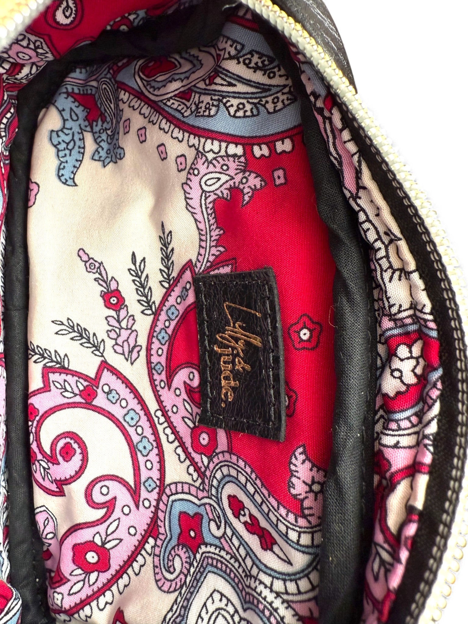 Close-up of the patterned lining fabric with a visible brand label inside a bag.