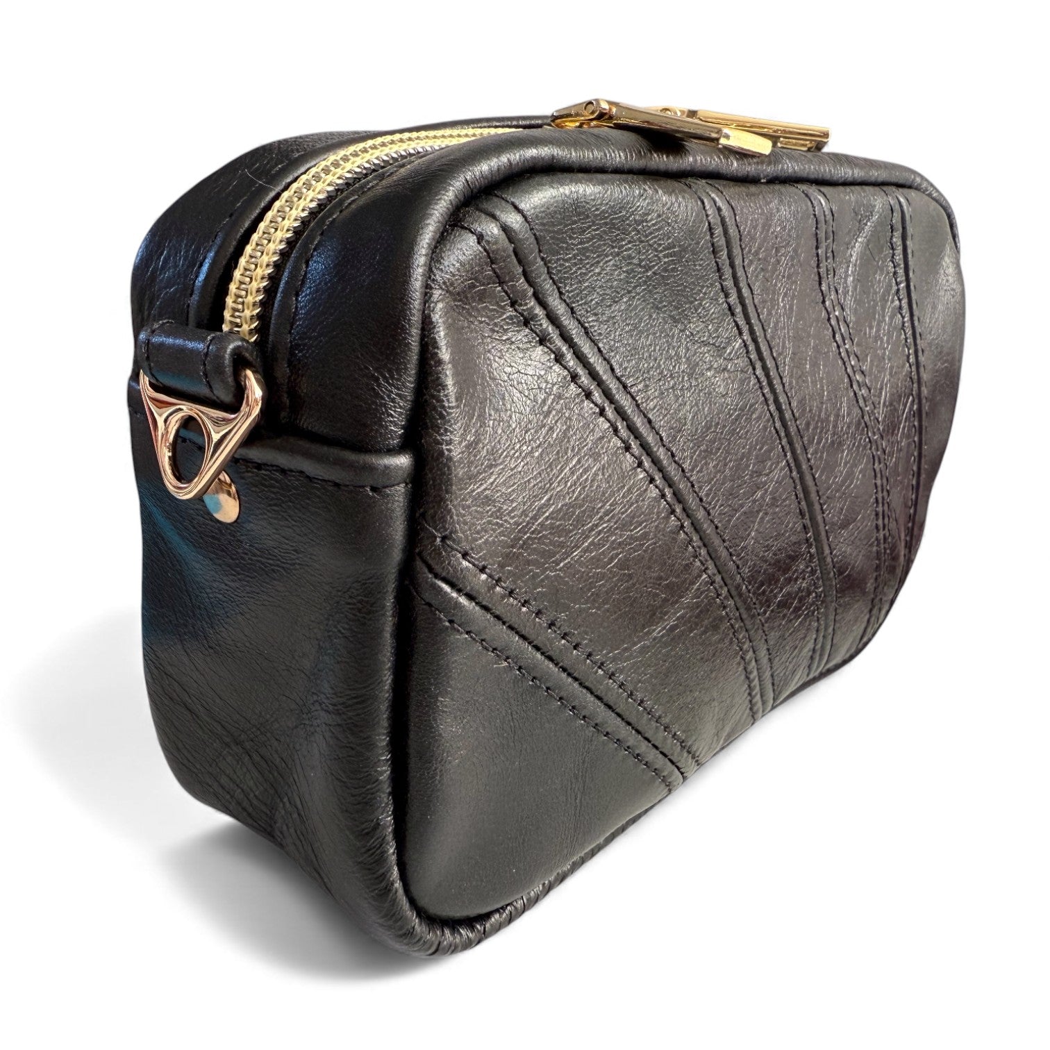 Black leather panelled bag with gold zipper and clasp on a white background