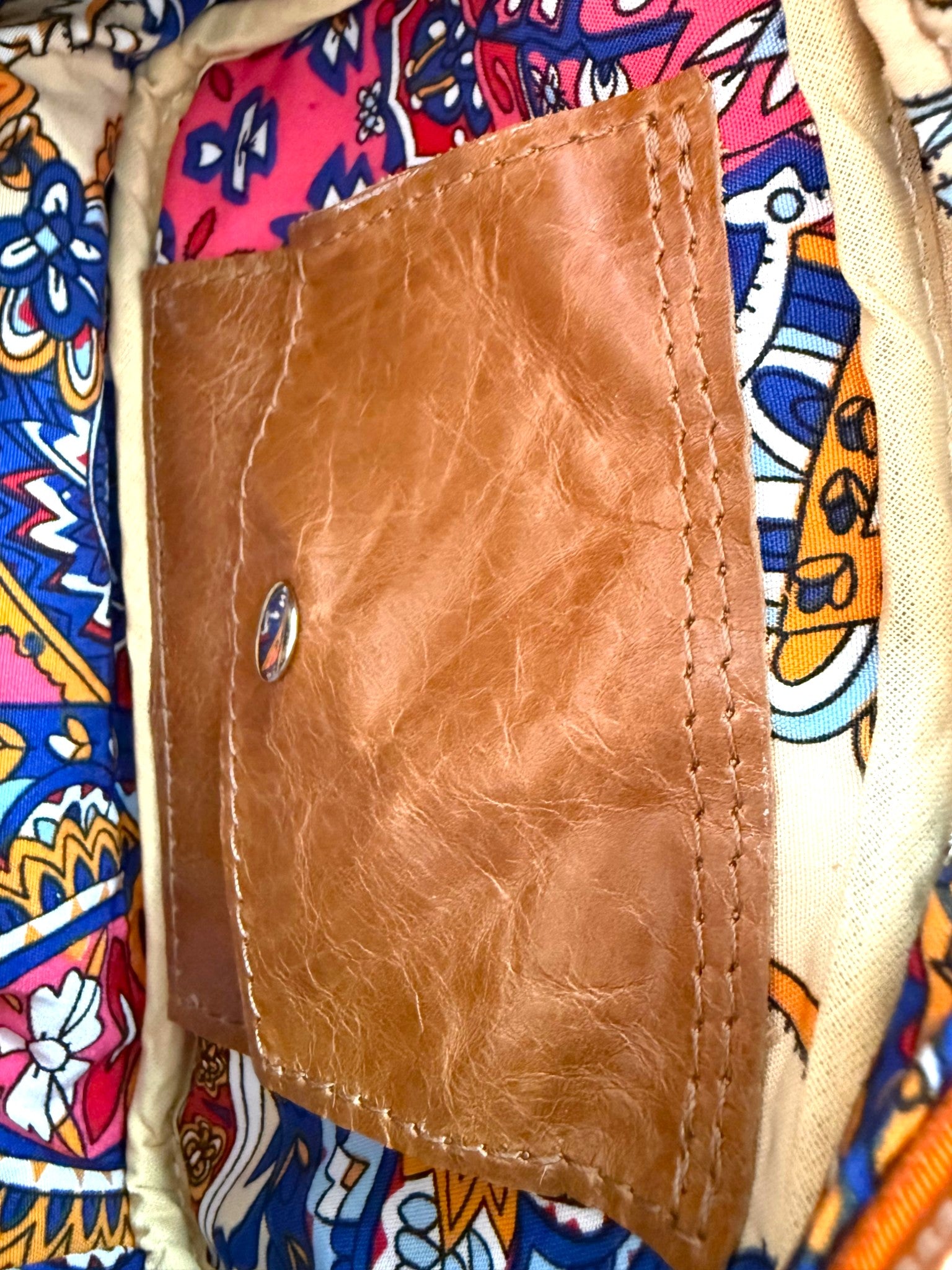 Interior view of the Tiny Harriet bag, highlighting the lining and closed integrated leather purse