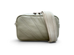A small rectangular crossbody bag in light sage green pebbled leather with diagonal stitched detailing and a woven shoulder strap, shown on a plain white background.