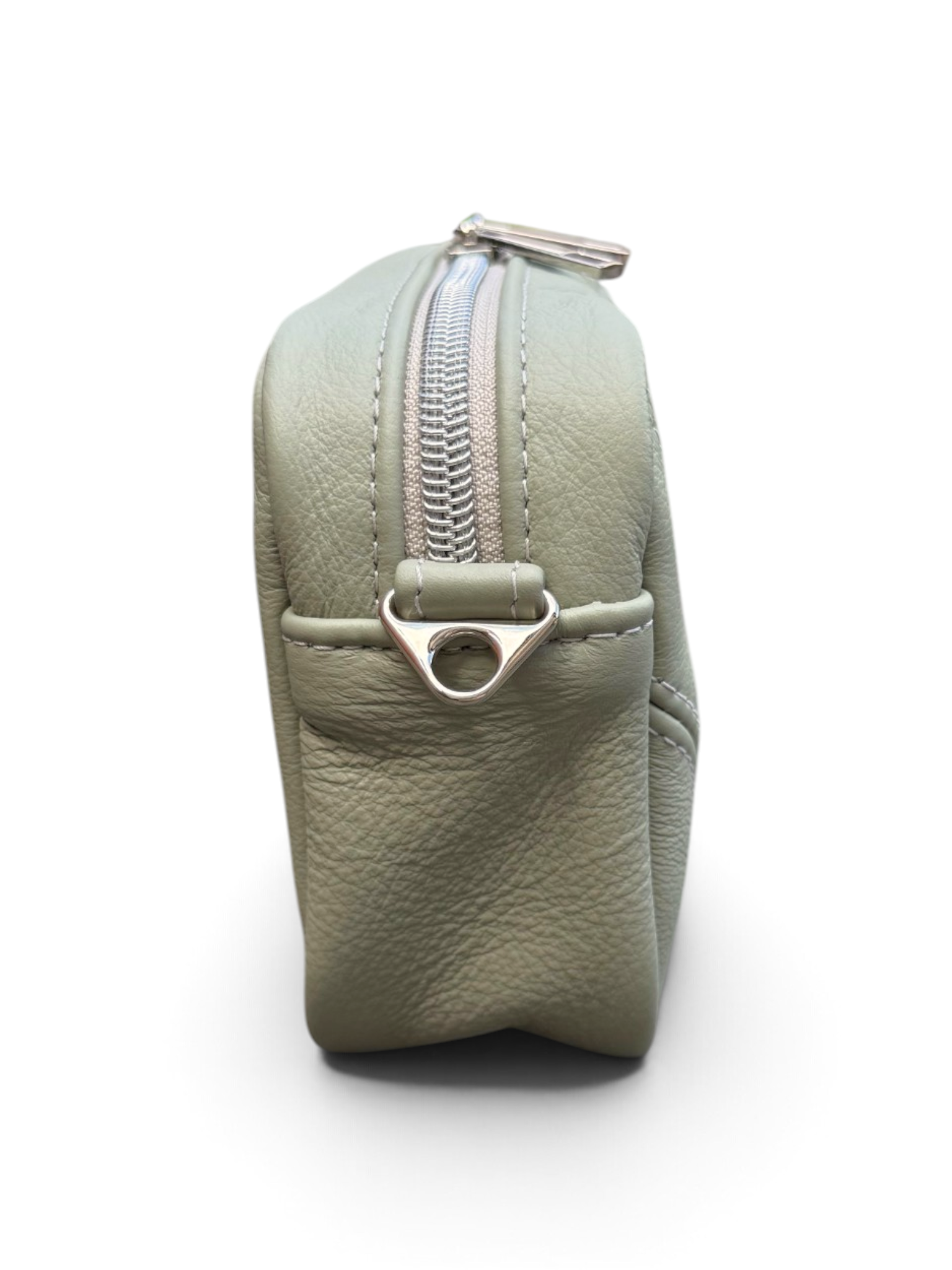A sage green textured leather zippered pouch shown from a side profile view on a white background.