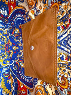 Tan leather integrated purse on a colourful patterned lining 