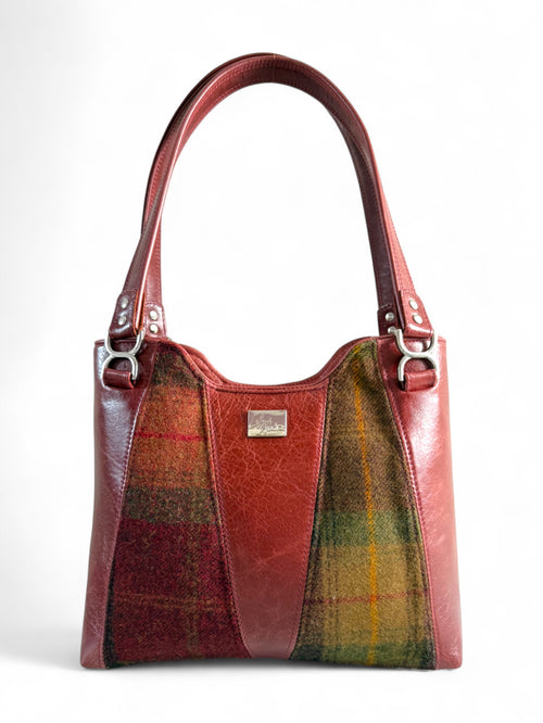Burgundy leather and autumnal tweed handbag with structured body, handmade in UK.
