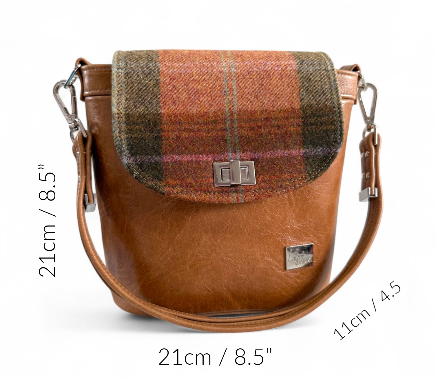 Brown leather crossbody bag with woollen tweed, plaid flap, measurements indicated: 21cm/8.5”, 21cm/8.5”, 11cm/4.5".
