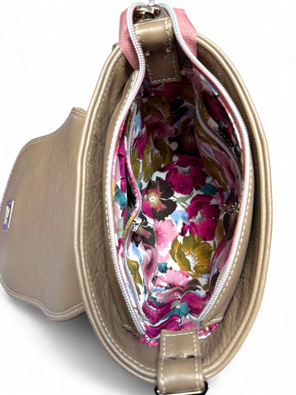 Top view with flap open showing interior and floral lining of Belle bag.
