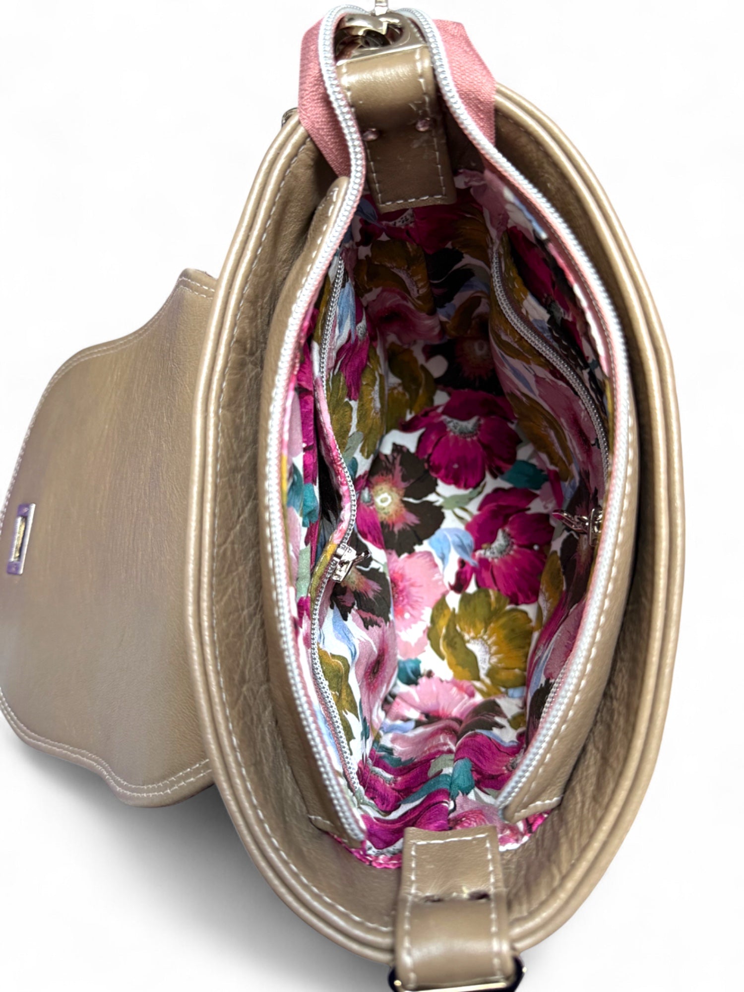 Top view with flap open showing interior and floral lining of Belle bag.
