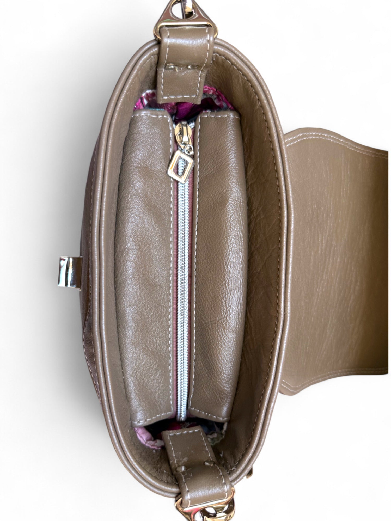 Top view with flap open showing the silver zipper opening of the hand crafted Belle handbag.
