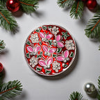 Decorative round plate with floral and butterfly design on a light gray background with Christmas decorations.