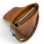 Top view with flap open showing the zipper opening at the top of the Belle bucket bag.

