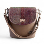 Taupe brown leather handbag with plaid patterned flap on a white background