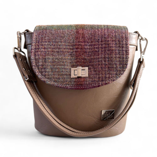 Taupe brown leather handbag with plaid patterned flap on a white background