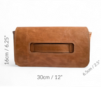 Tan leather clutch bag with measurements on a white background.
