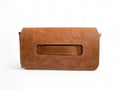 Tan Brown leather clutch bag, with hand strap on a white background. 