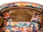 Interior view of Elland handbag. The fabric is khaki, orange and tan coloured floral patterned. The view shows a leather trimmed slip pocket and integrated leather purse
