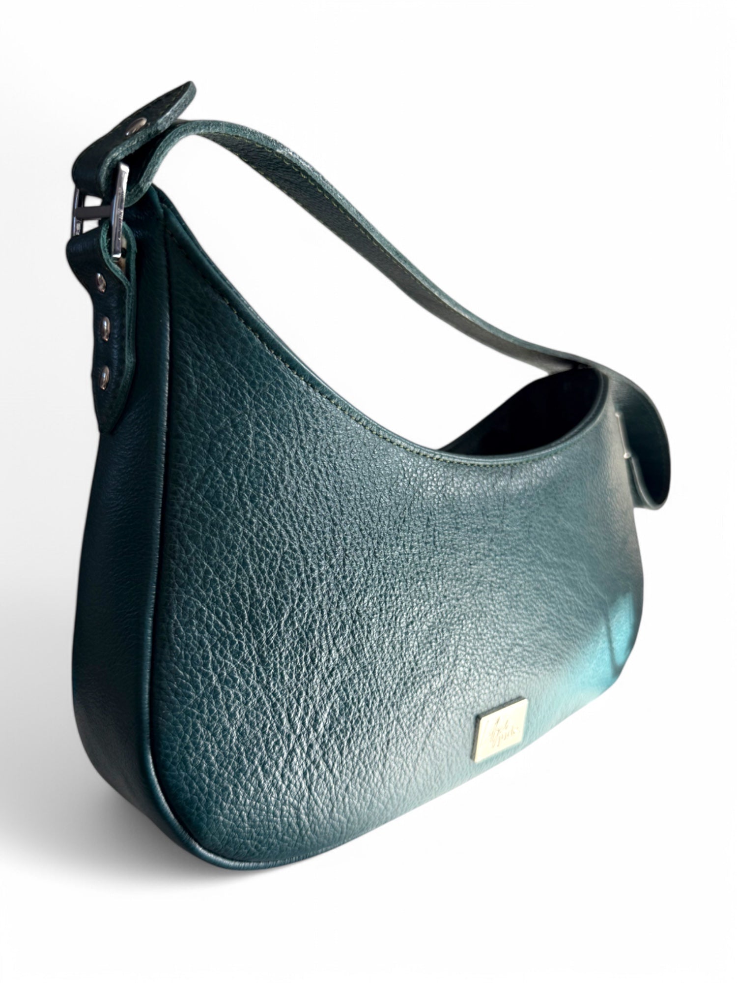 Dark teal green leather handbag with fixed handle on a white background