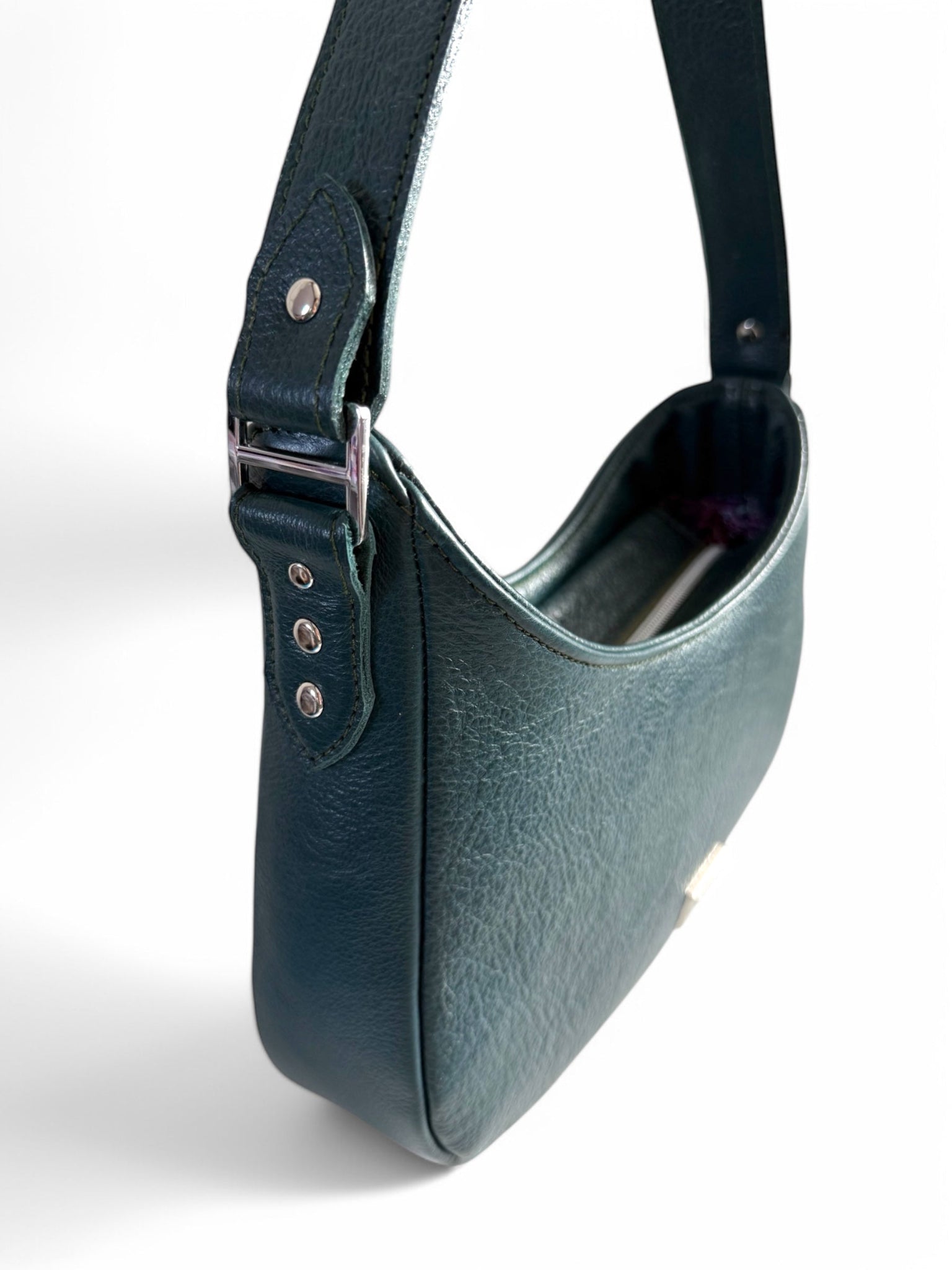 Teal blue, genuine leather handbag with a fixed strap and silver hardware on a white background