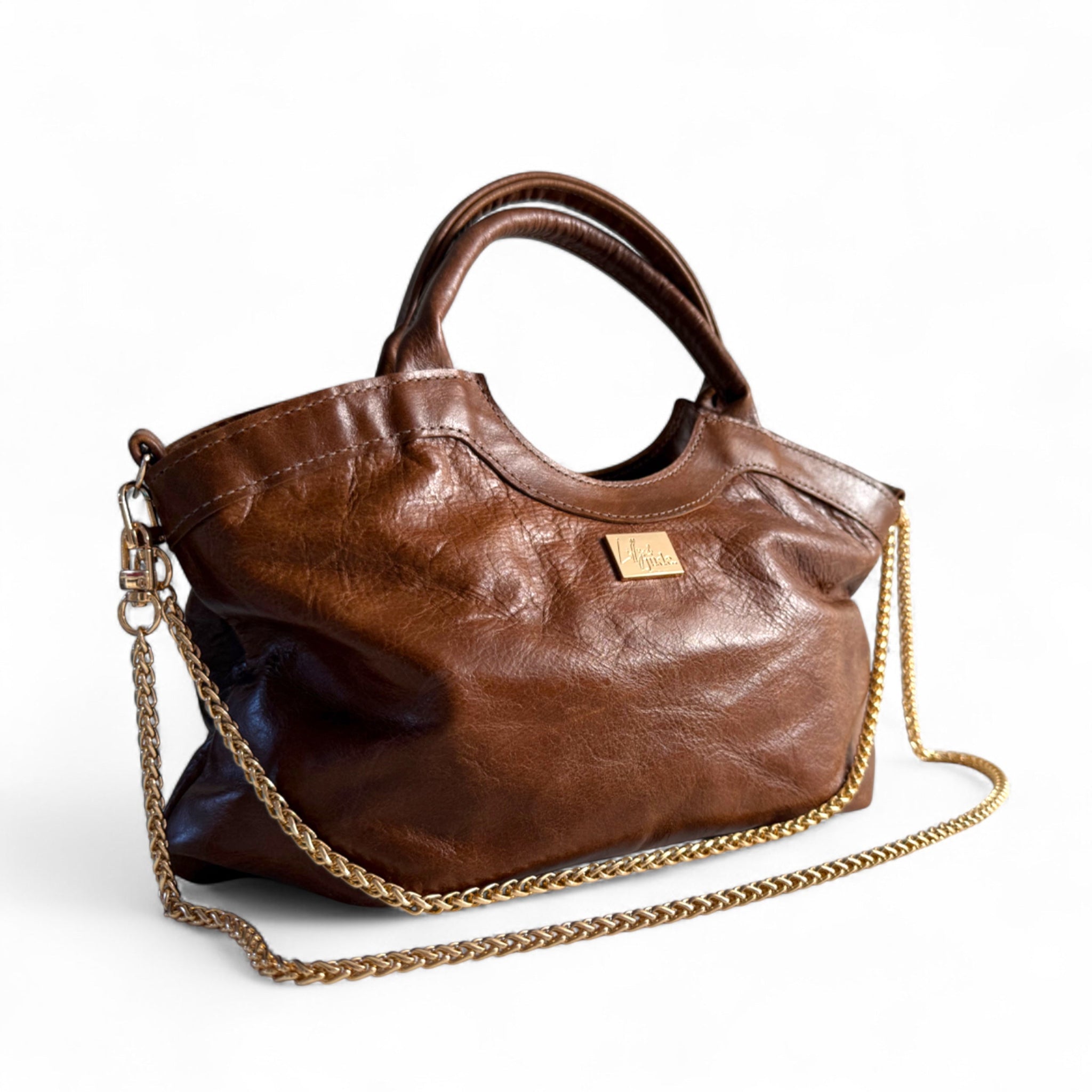 Brown, upcycled leather handbag with gold chain strap on a white background. Sustainable fashion handbag