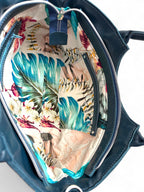 Interior view of the Flossy handbag showing the tropical style interior and leather trimmed slip pocket