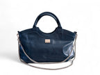 Flossy handbag in navy leather with a silver chain detail on a white background. Sustainable fashion by Lilly & Jude