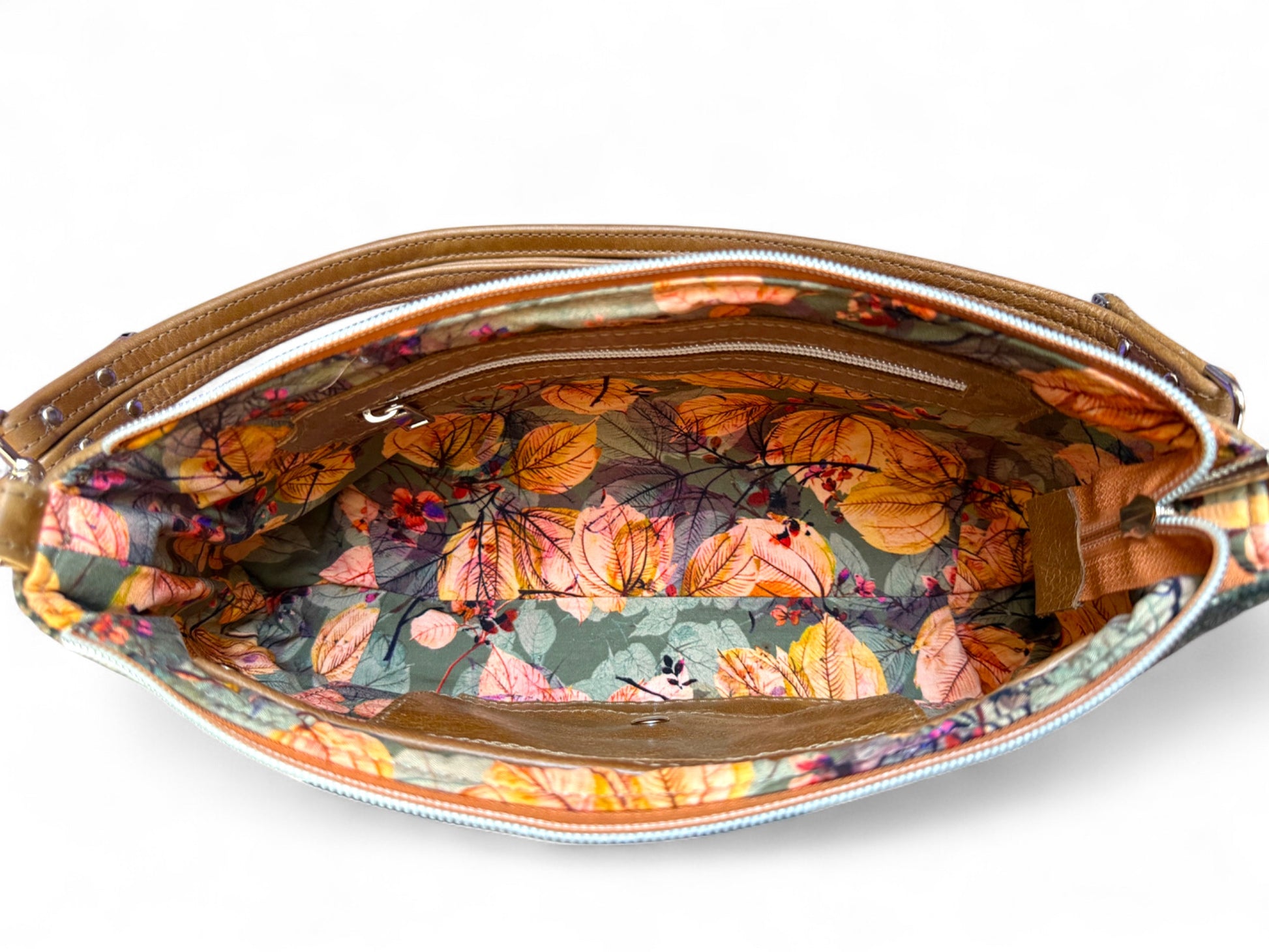 Birds Eye view of Elland handbag, showing the open zipped interior of the bag. Orange and khaki floral patterned fabric
