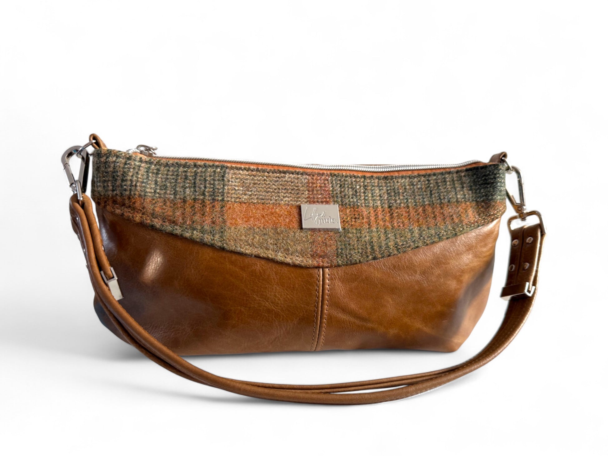 Front view of a tan coloured leather East/West style handbag with a matching woollen tartan tweed panel. 