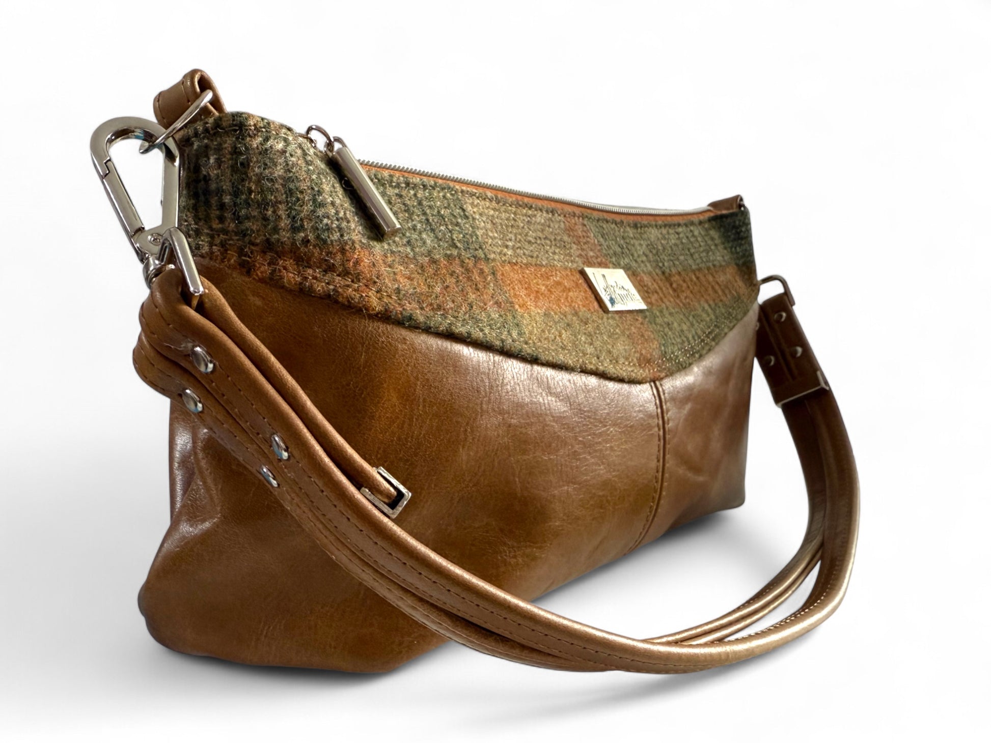 Side profile of Elland handbag showing leather and tweed mix and silver hardware.

