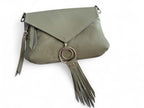 Soft pale olive green bag lying on a white background highlighting the flap and silver rings and tassel