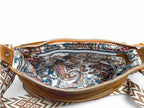 View from above of a tan coloured Olivia crossbody bag, opened and showing the beautiful paisley patterned lining and the interior zipper.