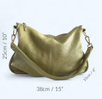 Pale green, upcycled leather slouchy bag sitting on a white background, with the measurements