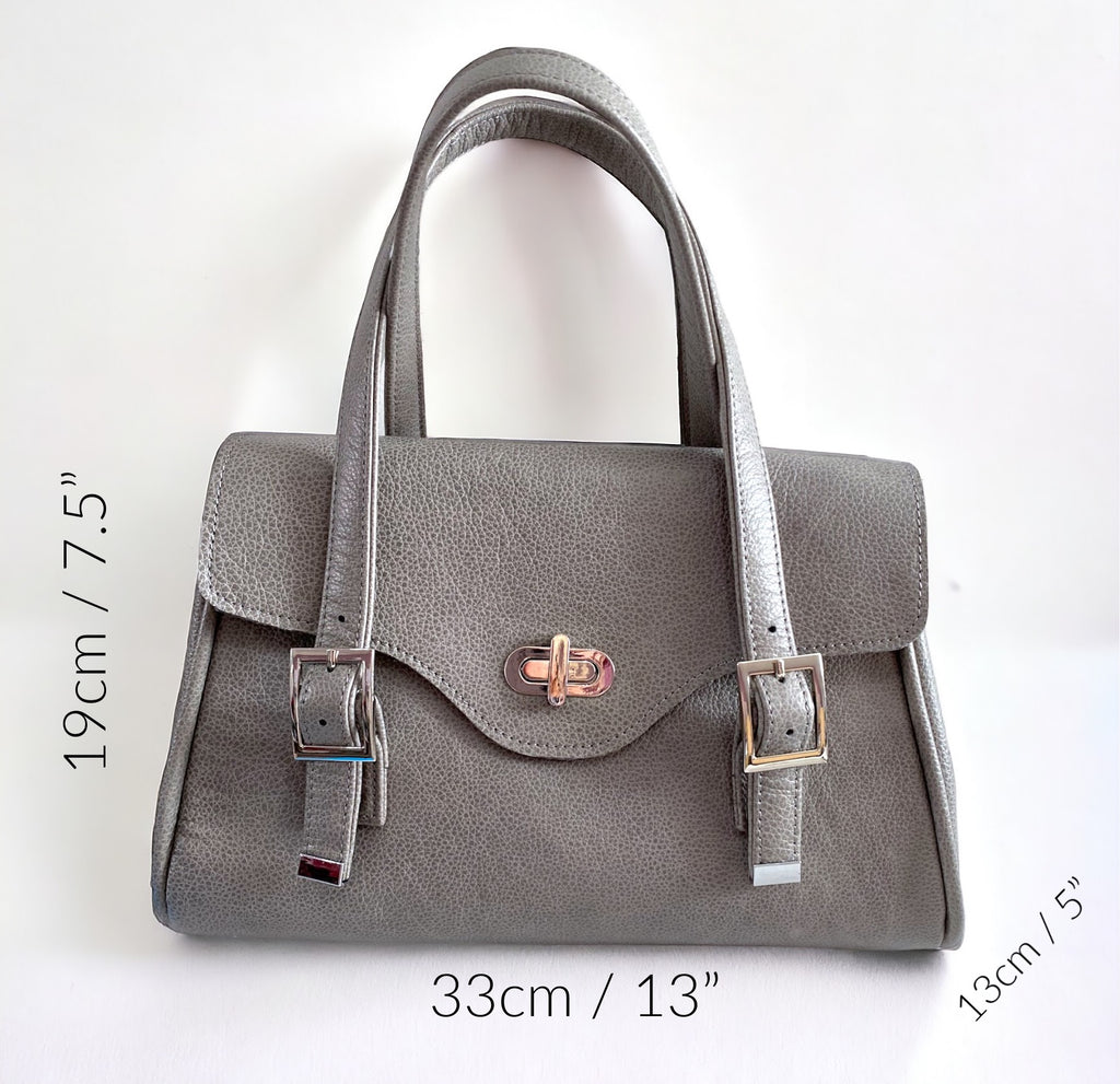 Grey real leather handbag and silver hardware with measurements on a white background