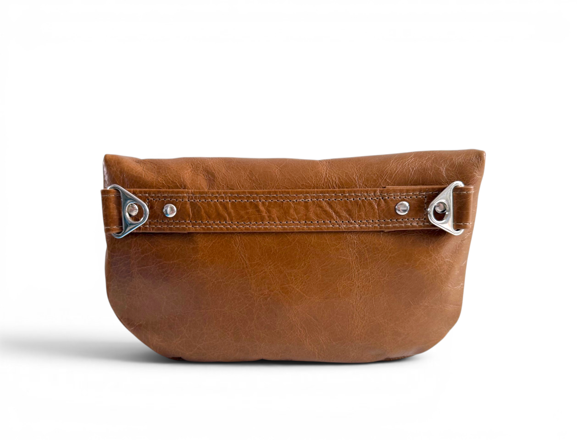 View of the back of a tan brown leather multiway bag with silver hardware on a white background