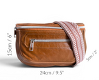 Tan brown leather bag with a strap, shown with measurements on a white background
