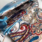 Close-up of a colorful paisley-patterned bag lining with integrated purse