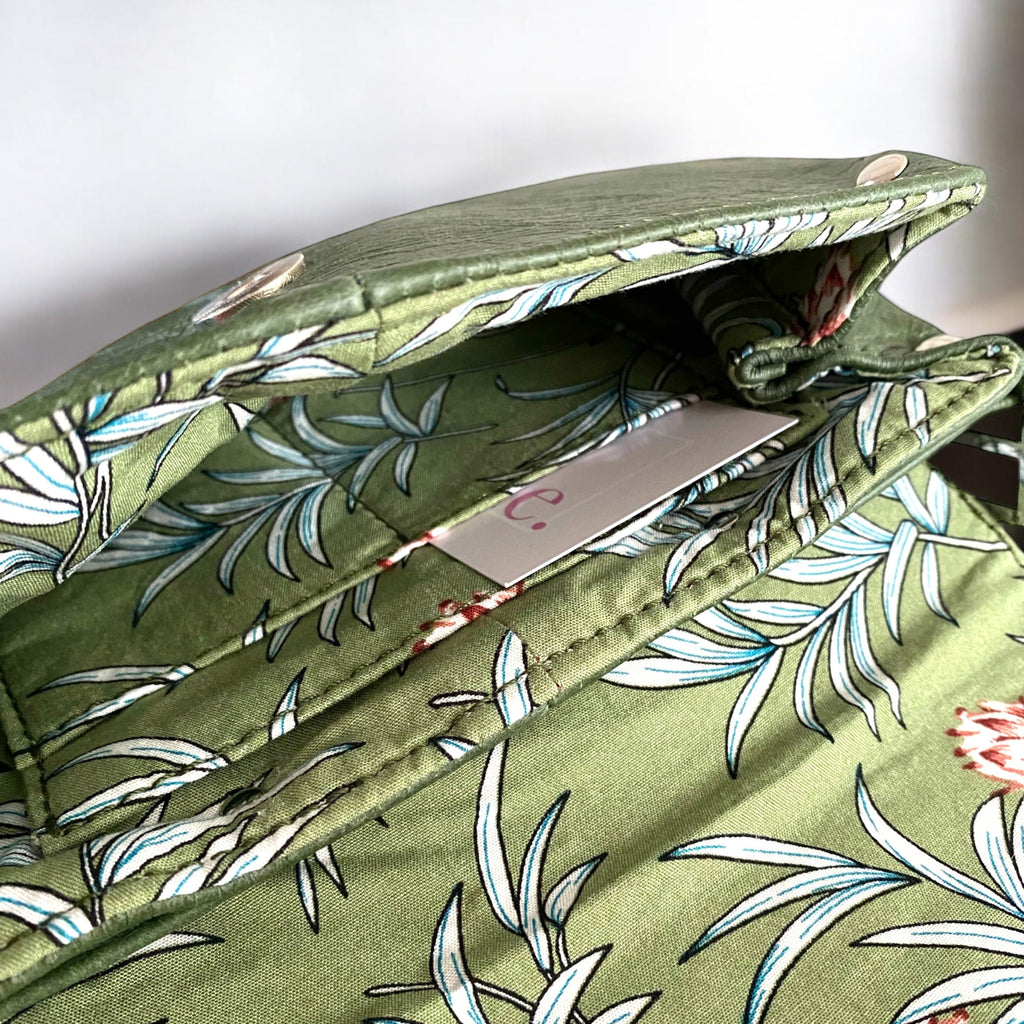 Green fabric lining with floral pattern and integrated purse