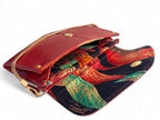 Red leather handbag with colourful patterned lining on a white background
