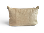 View of the back of a cream, butter yellow leather handbag on a white background