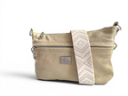 Front quarter view of the Starburn crossbody bag in butter yellow, cream leather with a strap on a white background