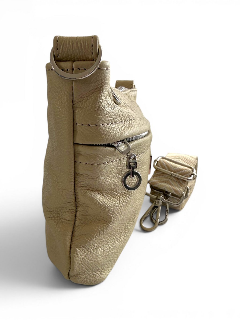 Side view of a butter yellow, full grain leather crossbody bag with a strap on a white background