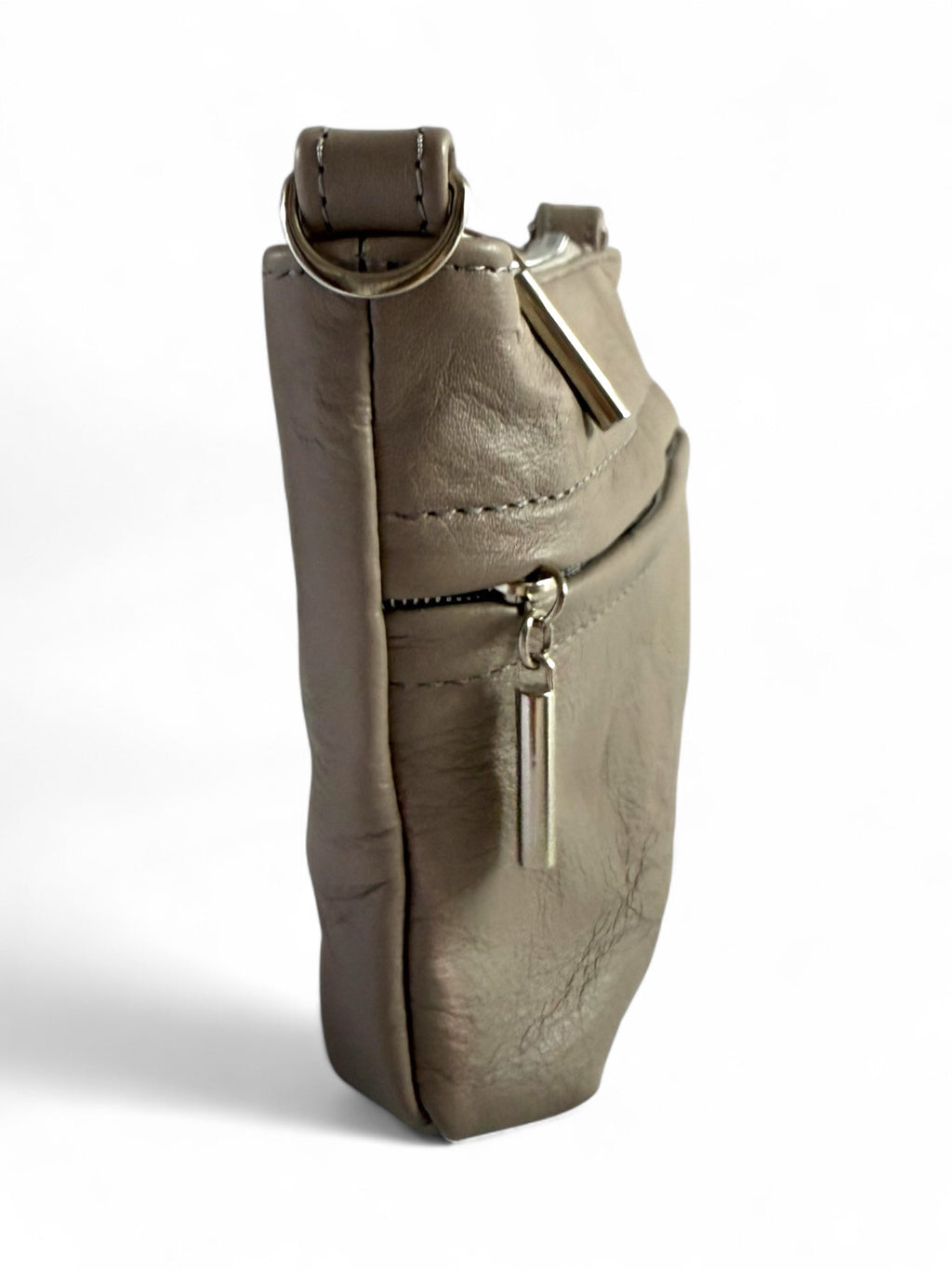 Side view of grey taupe crossbody bag with slim profile and leather detail.