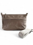 Grey taupe upcycled leather crossbody bag with chevron strap folded in front, handcrafted in the UK by Lilly & Jude.
