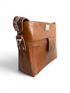 Brown leather handbag with silver hardware on a white background