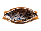 Tan brown leather crossbody bag with floral interior lining on a white background