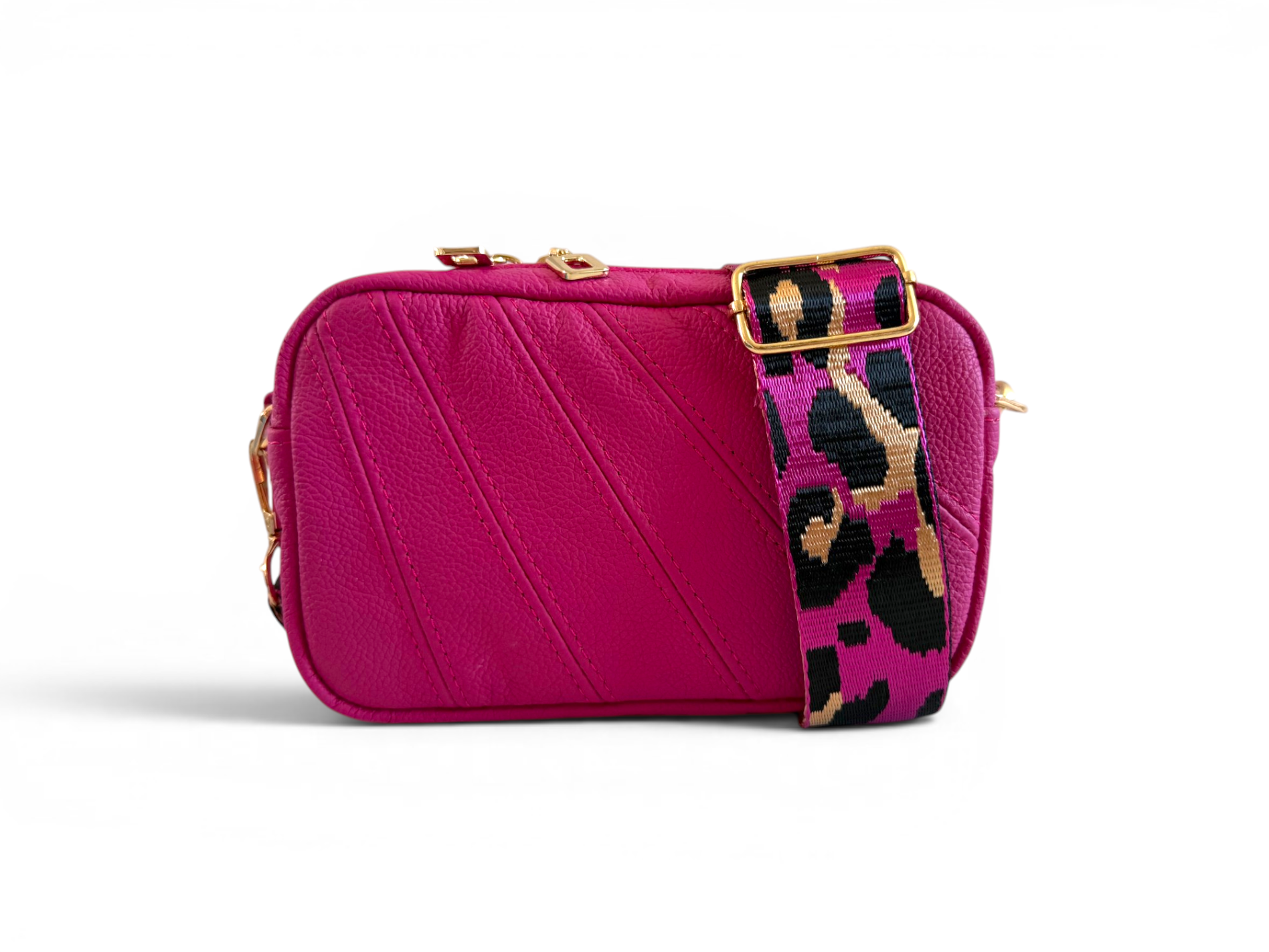 Hot pink, small crossbody bag with a colourful leopard print strap on a white background